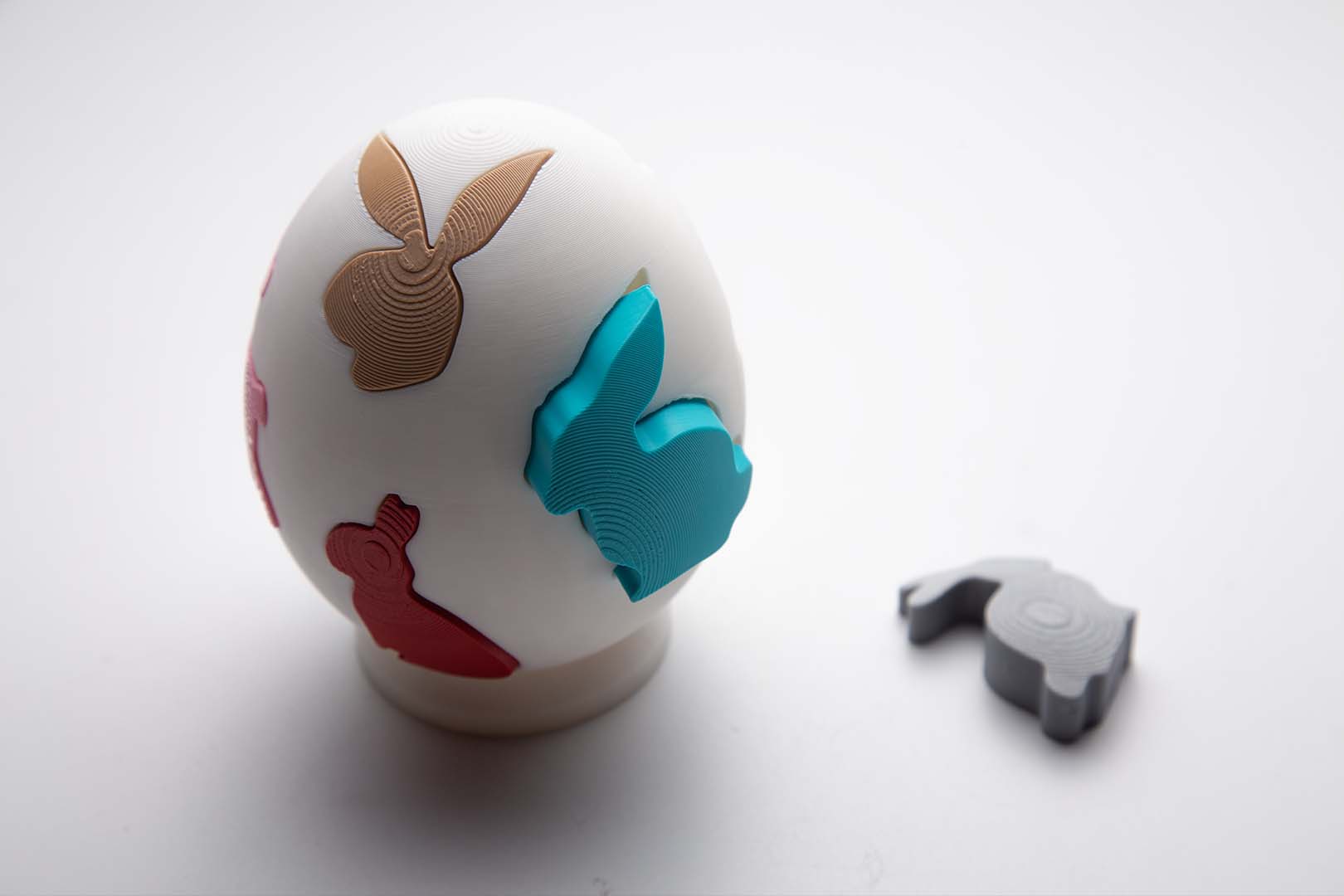 A completed 3D printed Easter egg puzzle showing the assembled colorful egg shape.