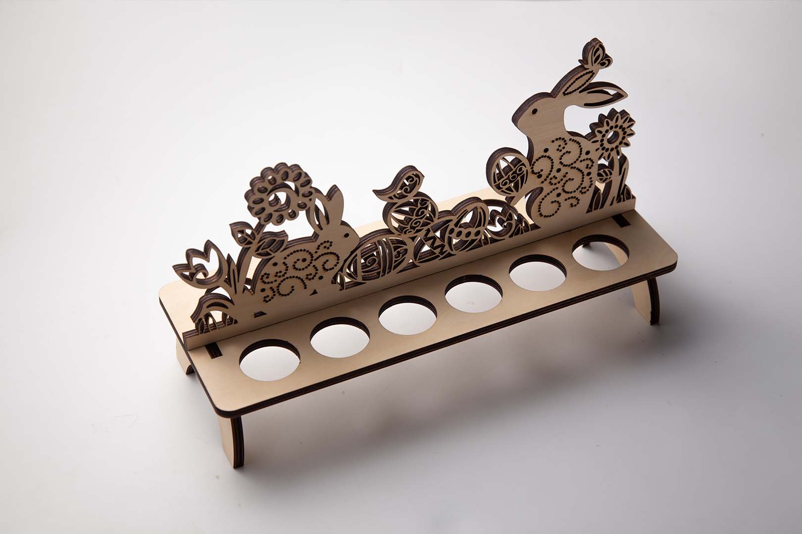 A collection of laser cut wooden Easter egg stands of different designs.